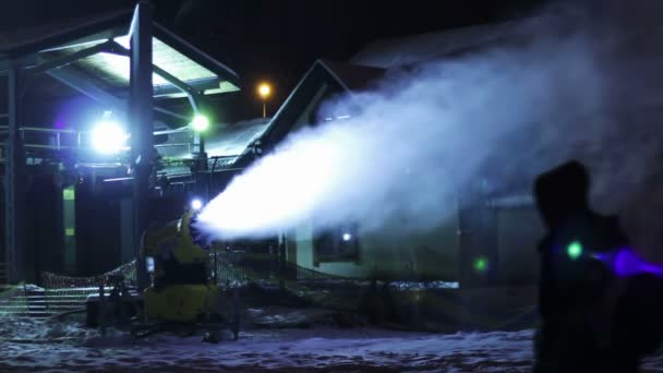 Snow cannons are working at night.