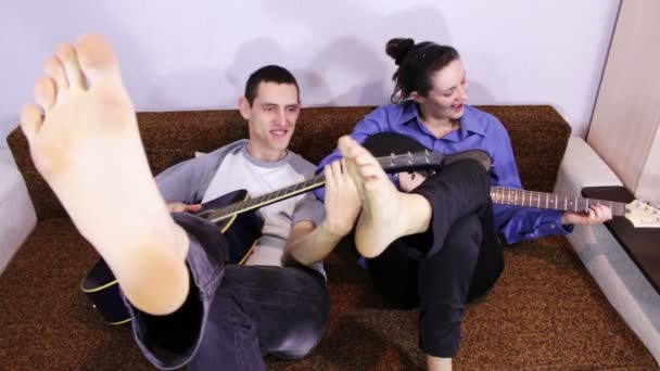 Creative happy couple playing guitar. — Stock Video