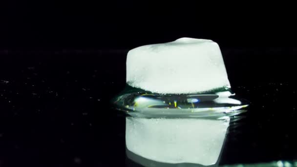 Ice Cube Melting and Moving on a Glass Surface — Stock Video