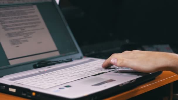 Man Works for Laptop Keyboard on Wooden Desk — Stock Video