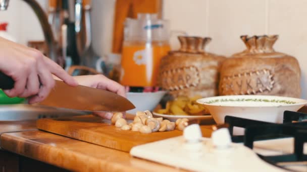 Woman Slices Mushrooms in the Kitchen — Stock Video