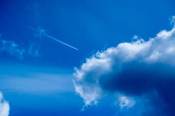 Blue sky with clouds  and airplane — Stock Photo, Image