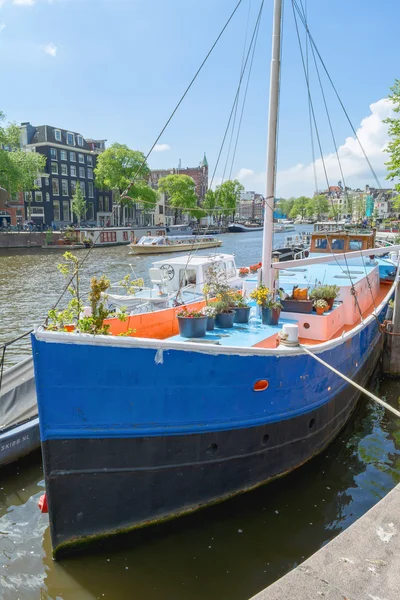 AMSTERDAM, NETHERLANDS - MAY 28, 2015: Colorful tour-boat with flowers in Amsterdam.