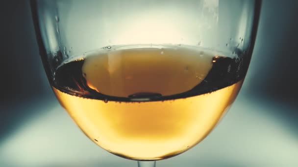 創造的なマクロ波のように側面から側面にガラスの中に白ワインが飛び散るのスローモーションビデオ ガラスのワインを閉じるを振りかける 快適な 少し柔らかいフェードと古いレトロなグランジヴィンテージスタイル — ストック動画