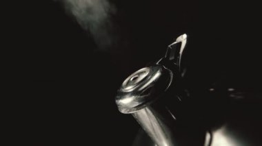 Kettle ıslık kapama makro yavaş çekim ham video, siyah arkaplanda buhar dokusu ile kaynayan çaydanlık.