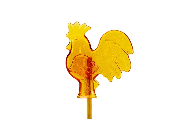 上一根棍子在孤立的白色背景上的公鸡形状的糖果 — 图库照片
