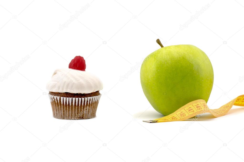 Green apple and cake with centimeter isolated on a white background