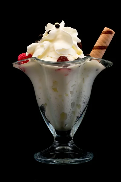 ice cream with raspberries in a beautiful glass isolated on a black background