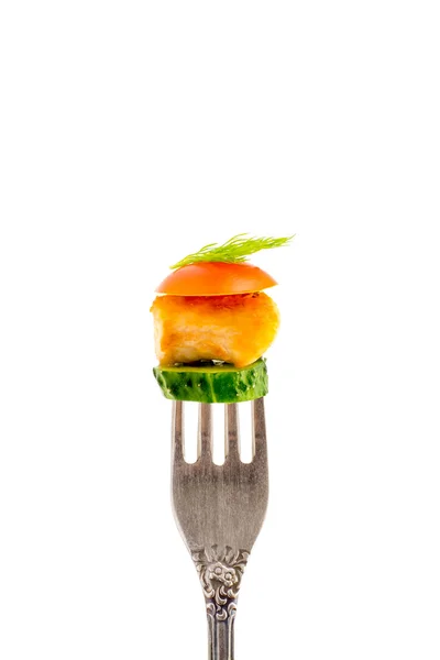 A piece of fried meat with vegetables on a fork on a white background vertical Royalty Free Stock Photos