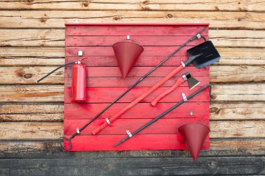 instruments to extinguish a fire on a wooden wall clipart