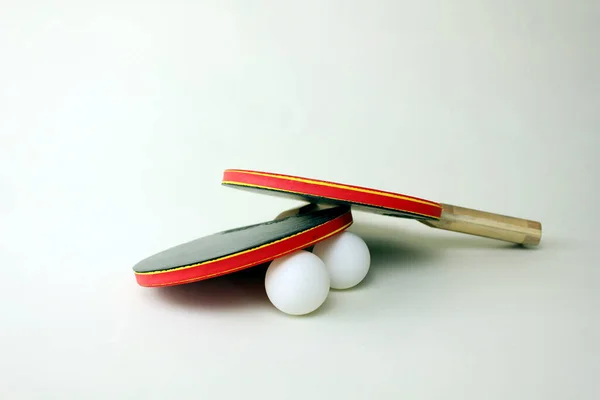 Ping pong paddles and balls on white background.