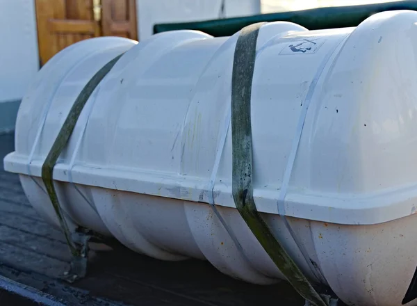 Life raft secured on the deck of a ship.