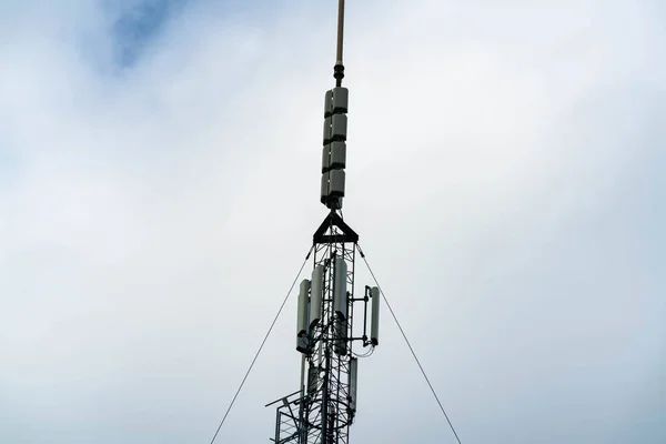 Large cellular communications tower with arrays, antennas and dishes for providing mobile connections as well as both 4G and 5G internet. . High quality photo