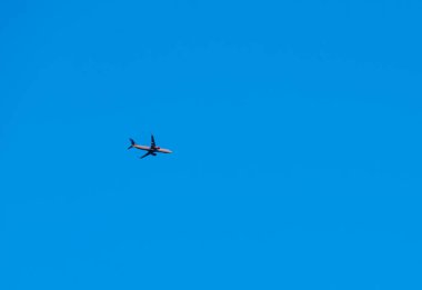 A Scandinavian airlines Boeing 737-800 flying high above the ground on route with clear blue skies. . High quality photo