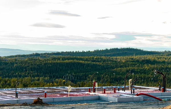 House foundation in concrete with pipes and wire connections sticking out, ready for walls. Overseeing a wild forest valley. . High quality photo