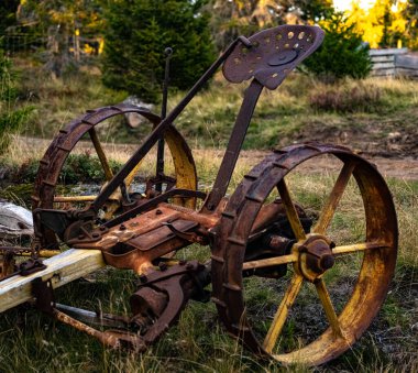 Rusted antique seed machine that used horse power. . High quality photo
