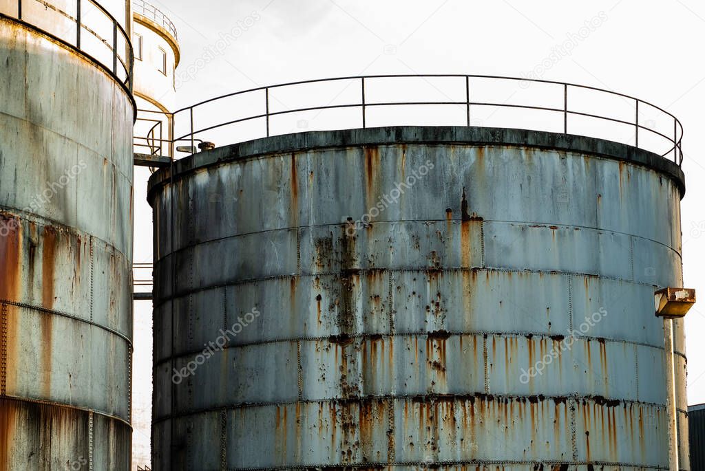 Old and rusted steel silos for storage of solids and liquids. . High quality photo