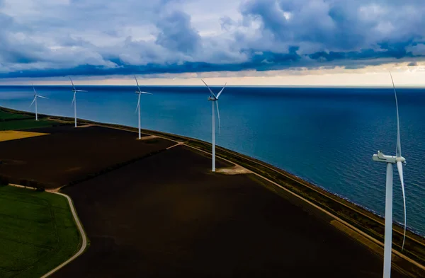 Wind turbines by the sea, generating clean energy on a stormy day. . High quality photo