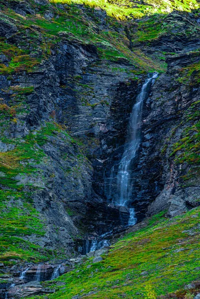 Waterfall free falling from a steep mountain slope. . High quality photo
