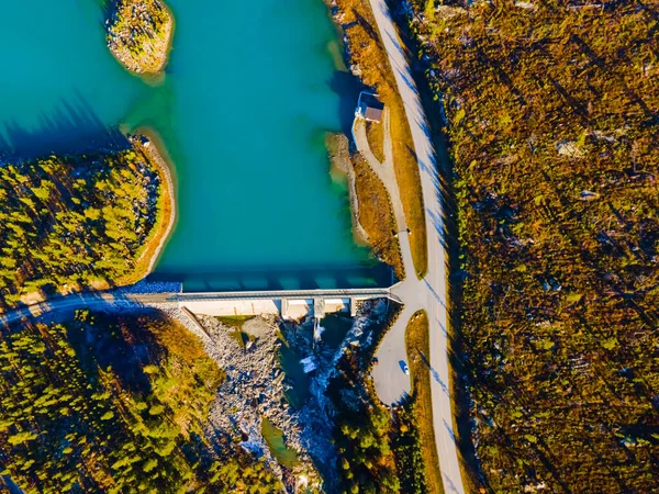 Hydro electric dam with reservoir and river seen from above. . High quality photo