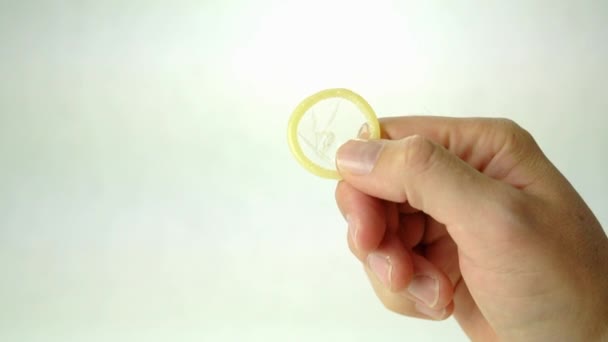 Male Hand Holding Condom Concept Safe Sex Isolated White Background — Αρχείο Βίντεο