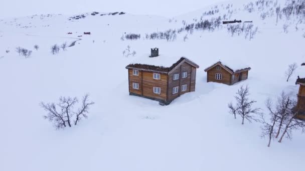 传统的大的经典的小木屋在山上的一个雪天寒冷的冬天 4K空中飞越 — 图库视频影像