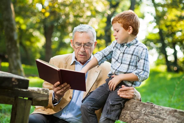 Grandfather and grandson in park — Stock Photo, Image