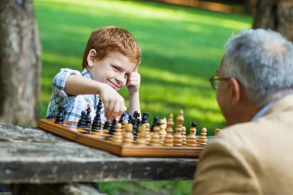 Grandfather and grandson in park