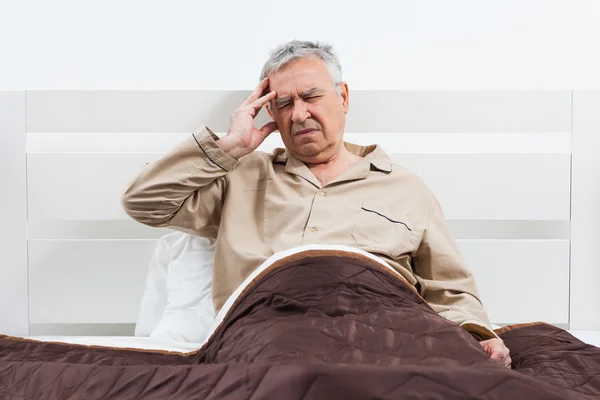 Senior man in bed — Stock Photo, Image