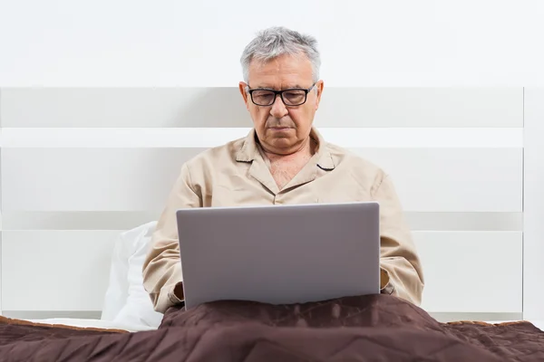 Senior man in bed — Stock Photo, Image