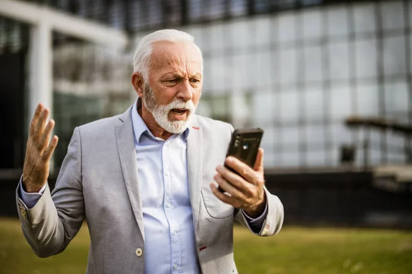 Senior Businessman Messaging Smartphone Front Company Building Angry — Stock Photo, Image