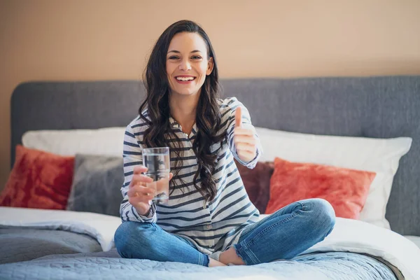 Happy Young Woman Sitting Bed Her Home Looking Camera Holding — Stock Photo, Image