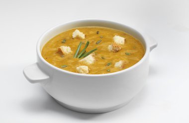 Green vegetables soup puree with croutons on a white background