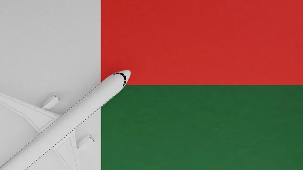 Top Down View of a Plane in the Corner on Top of the Country Flag of Madagascar
