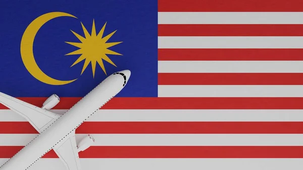 Top Down View of a Plane in the Corner on Top of the Country Flag of Malaysia