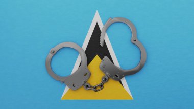 Yarı açık çelik kelepçeler ortada ve ulusal Saint Lucia bayrağının üstünde.