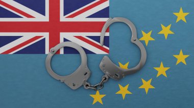 Yarı açık çelik kelepçe ortada ve Tuvalu bayrağının üstünde.