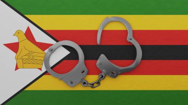 Yarı açık çelik kelepçeler ortada ve ulusal Zimbabwe bayrağının tepesinde.