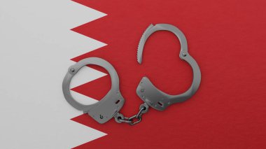 Yarı açık çelik kelepçe ortada ve ulusal Bahreyn bayrağının üstünde.