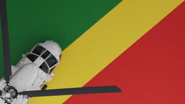 Sol alt köşedeki Beyaz Helikopter 'in yukarıdan görünüşü ve Kongo Cumhuriyeti Ulusal Bayrağının tepesi.