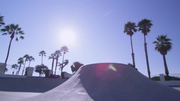 A BMX bike rider jumps at a skatepark — Stock Video