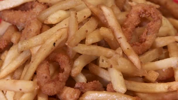 Greasy fries and onion rings — Stockvideo