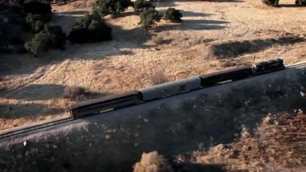 Un tren viaja por una zona remota — Vídeo de stock