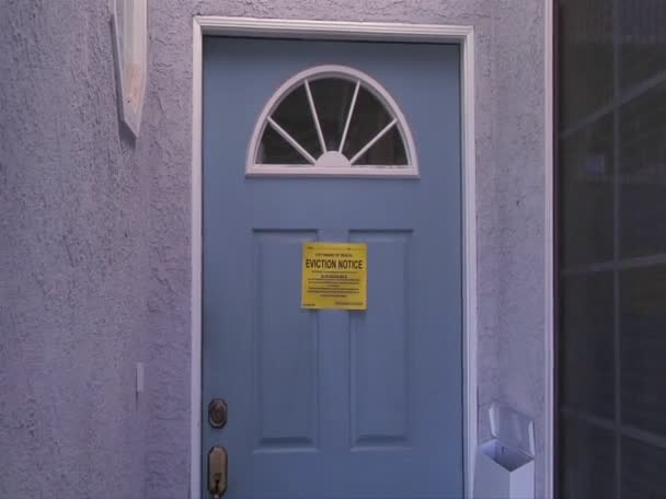 Door with an eviction notice signals the worldwide mortgage crisis — Stock Video