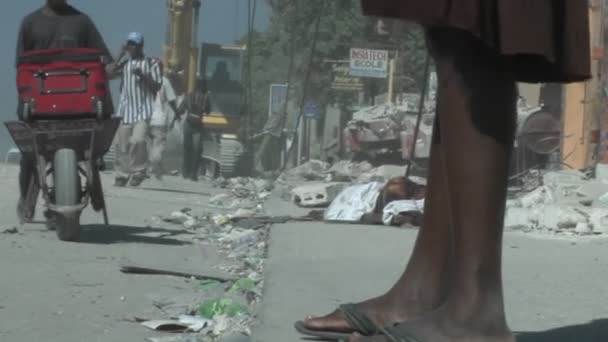 People walk amongst the rubble — Stock Video