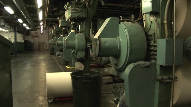 Worker watching paper rollers — Stock Video