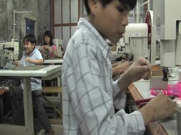 Asiáticos jovens costurar em uma fábrica — Vídeo de Stock