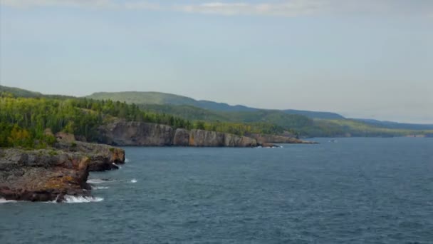 Wooded hills surround a coastline — Stock Video