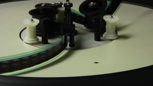 Film strip spools through a projector — Stock Video