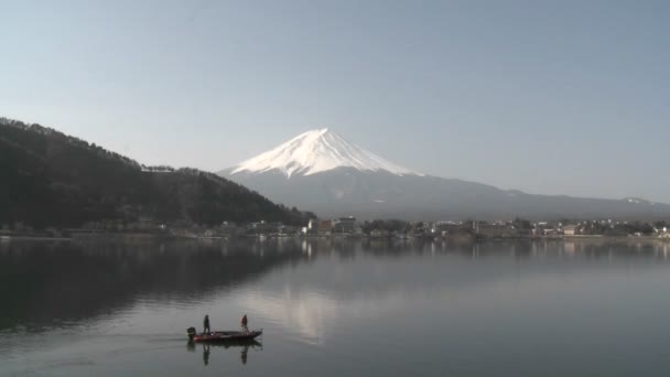 Гора. Фудзи и рыбаки, отраженные в озере — стоковое видео